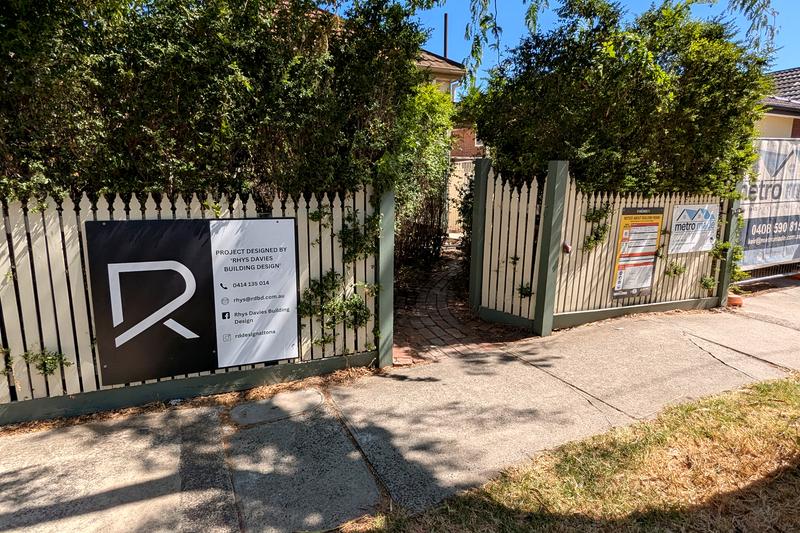 RD Building Design signage on a fence of a building development