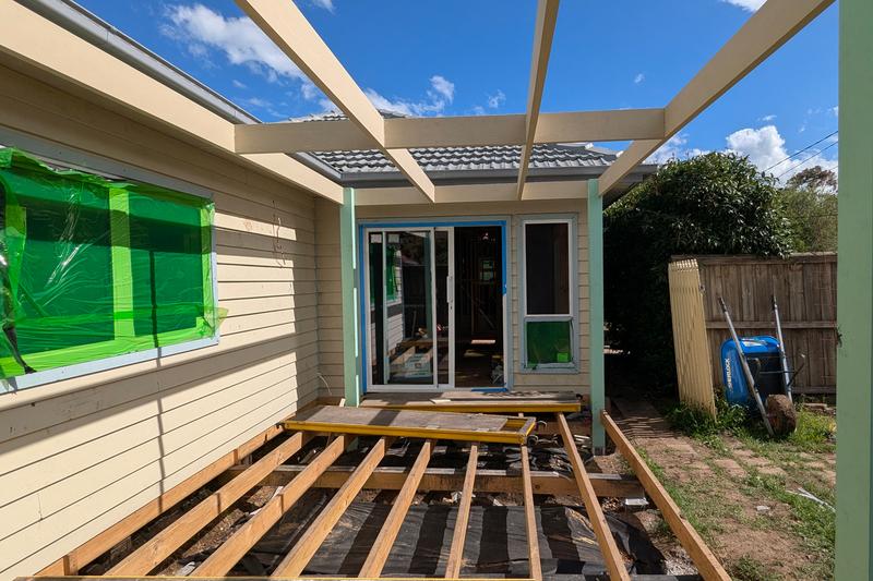 Construction site showing deck being built on house